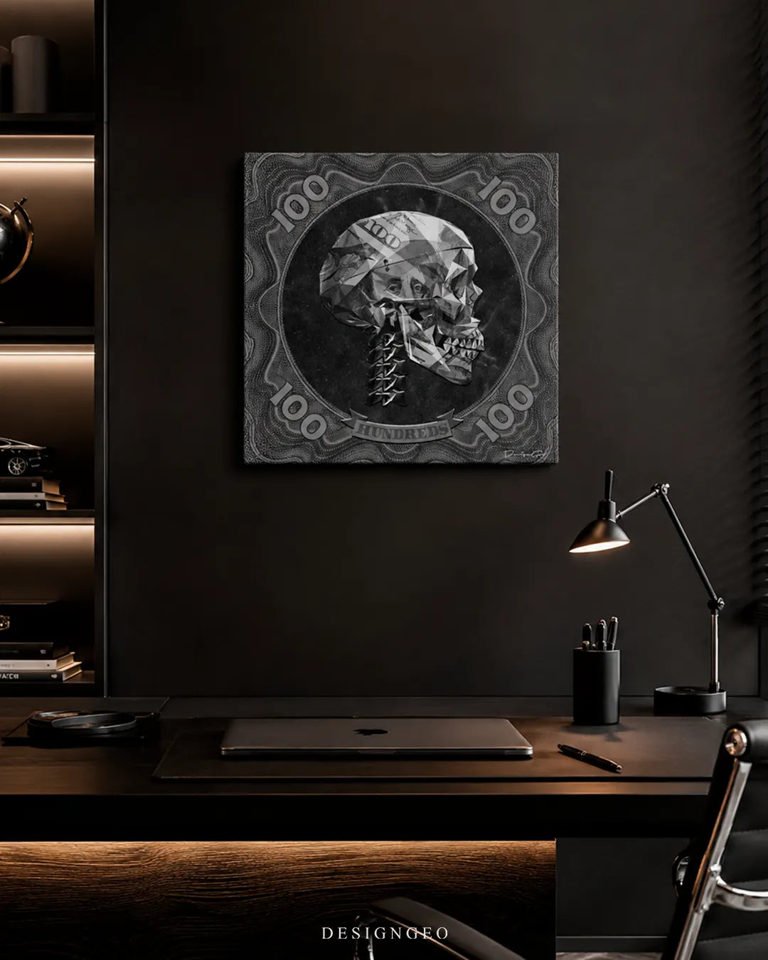 Square monochrome geometric dollar skull canvas print mounted above a sleek dark executive desk with a laptop and desk lamp in a modern black office