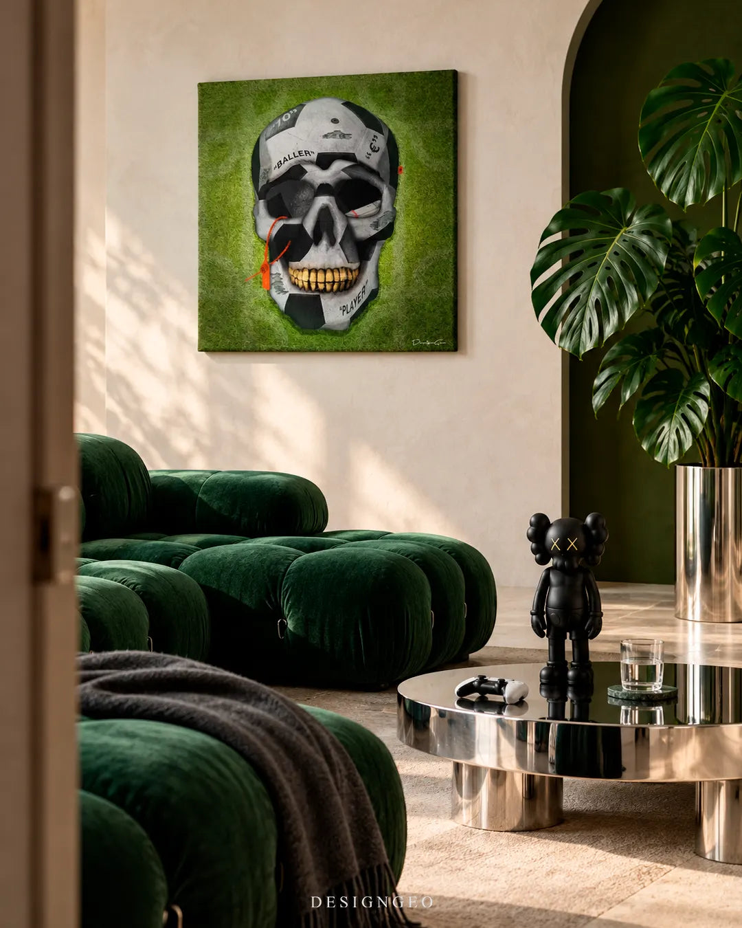 Modern luxury living room decor featuring a square canvas print of a soccer ball skull with gold teeth against a green grass background above a velvet sofa