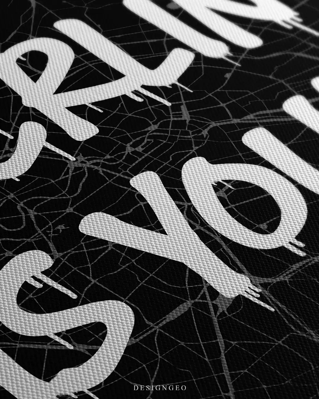 Detailed view of the "Berlin is Yours" art piece, showcasing the sharp contrast between the intricate German street grid and the bold white spray-paint style lettering