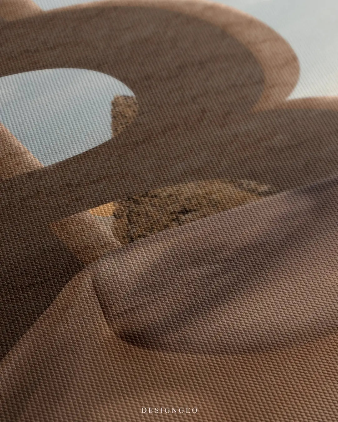 Close-up of modern crypto wall art featuring a golden Bitcoin symbol integrated into a minimalist desert landscape with soft sand dunes and a clear sky