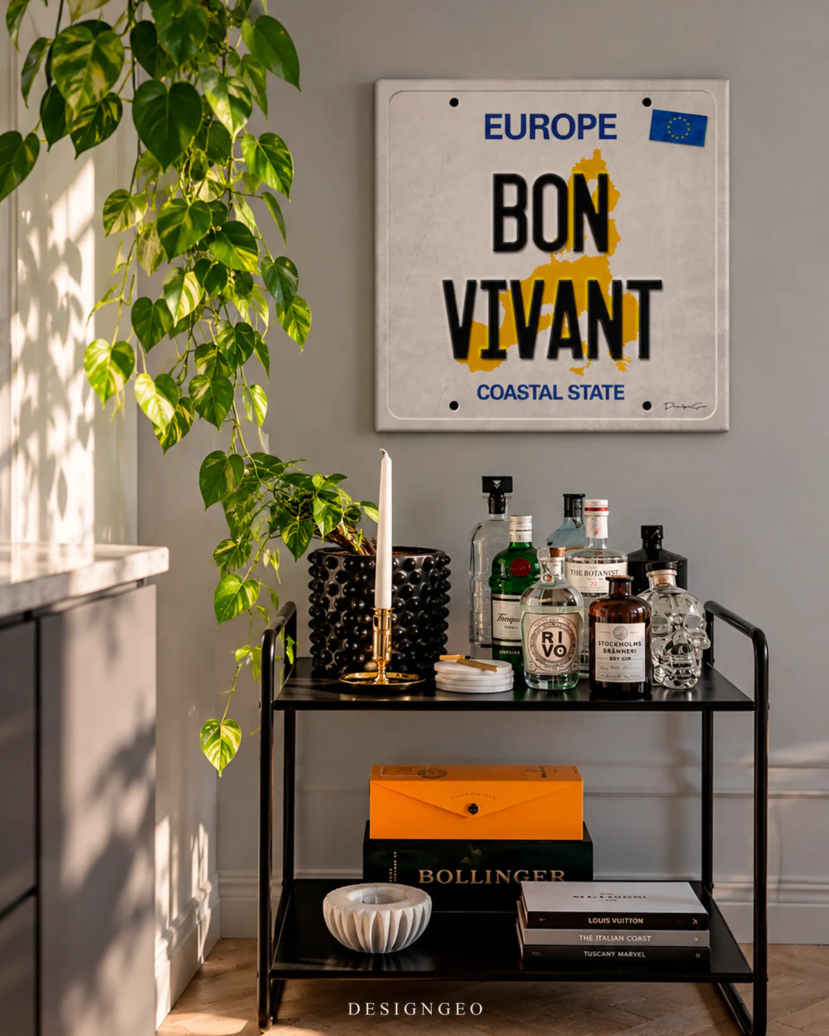 Europe Bon Vivant license plate square canvas wall art mounted on wall above a bar cart with liquor bottles in modern home interior 0.75 inch thin wrap