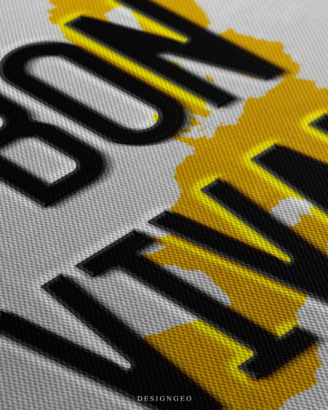 Angled macro view of a canvas print highlighting the fine weave texture and 3D embossed black lettering of BON VIVANT over a yellow European continent map
