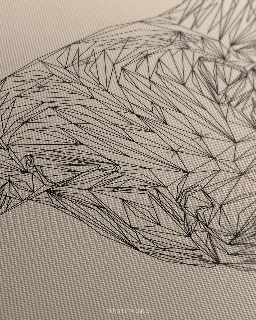 Close-up of minimalist wall art featuring a bull head outline in clean black lines on a neutral beige background with subtle canvas textures