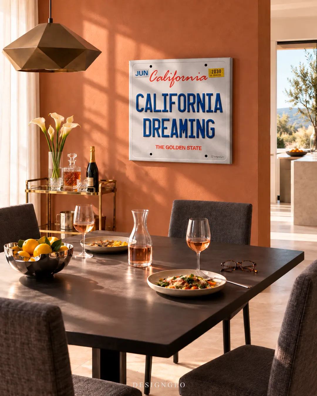 Modern luxury dining room featuring a square canvas print of a vintage California license plate with CALIFORNIA DREAMING text mounted on a warm terracotta wall