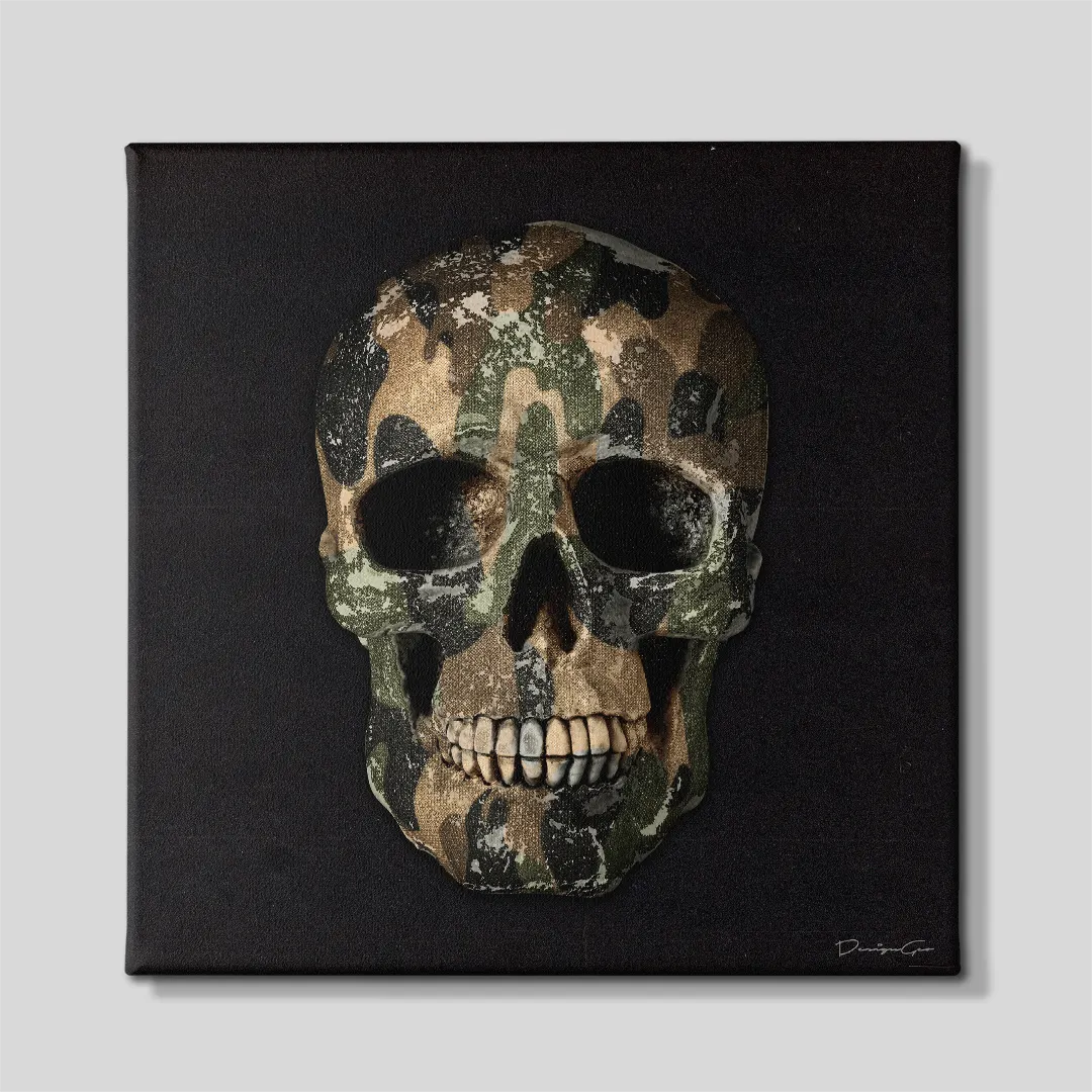 Front view of a square black canvas print featuring a human skull wrapped in a green and tan military camouflage pattern