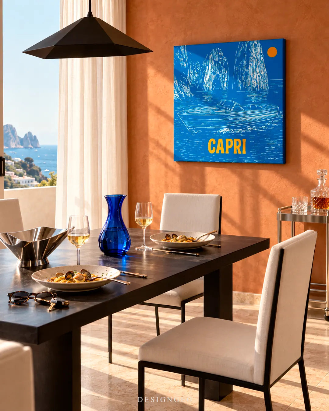 Luxury dining room with ocean view featuring a square Capri blue canvas print with yellow CAPRI lettering mounted on a warm terracotta wall above a dark dining table