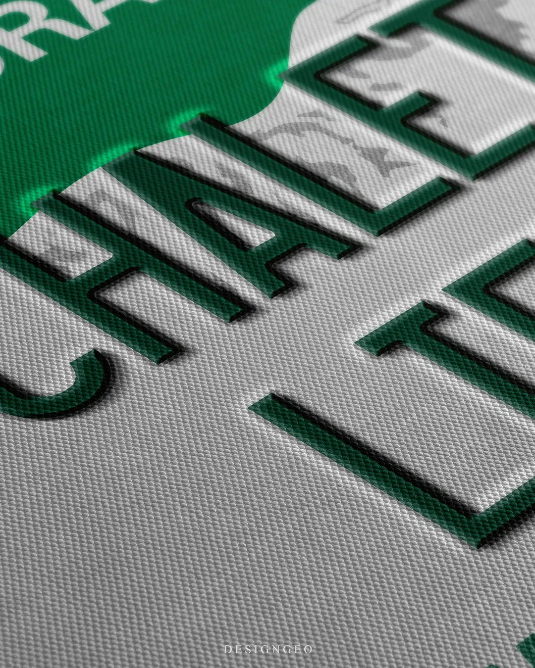 Angled close-up detail shot highlighting the 3D dark green embossed CHALET LIFE letters, subtle green glow drop shadow, and fine woven canvas fabric texture
