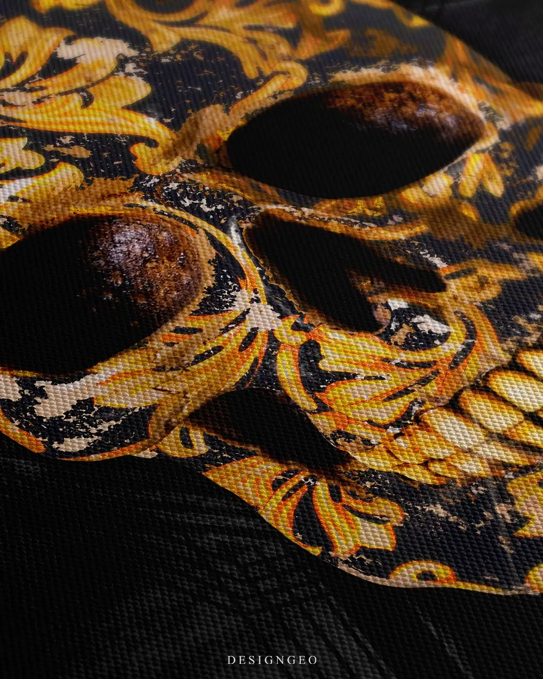 Close-up of luxury wall art featuring a designer-themed skull with high-fashion patterns and gold accents on a solid black background