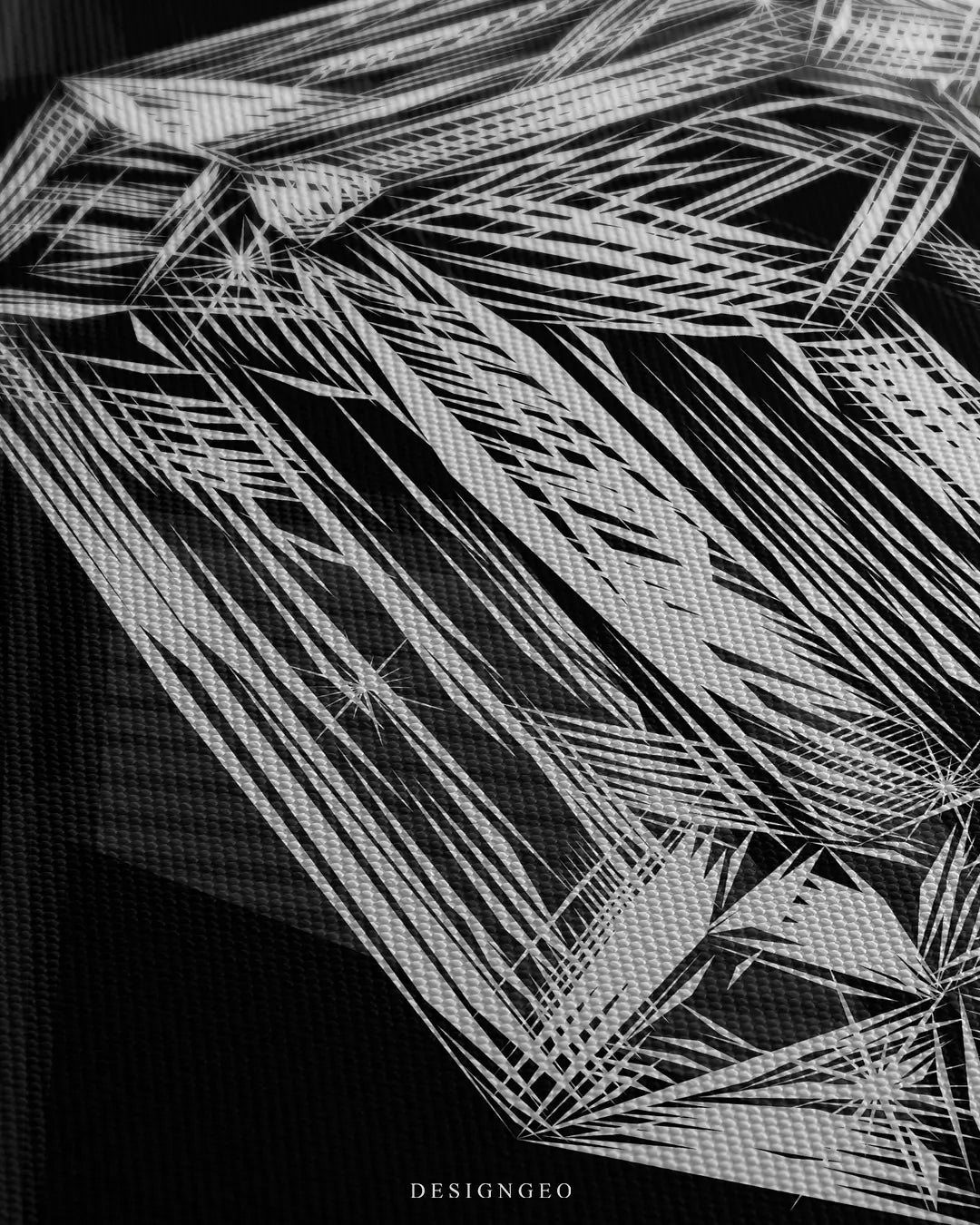 Close-up of minimalist wall art featuring a white technical sketch of a diamond with GIA-style blueprint lines on a solid black background