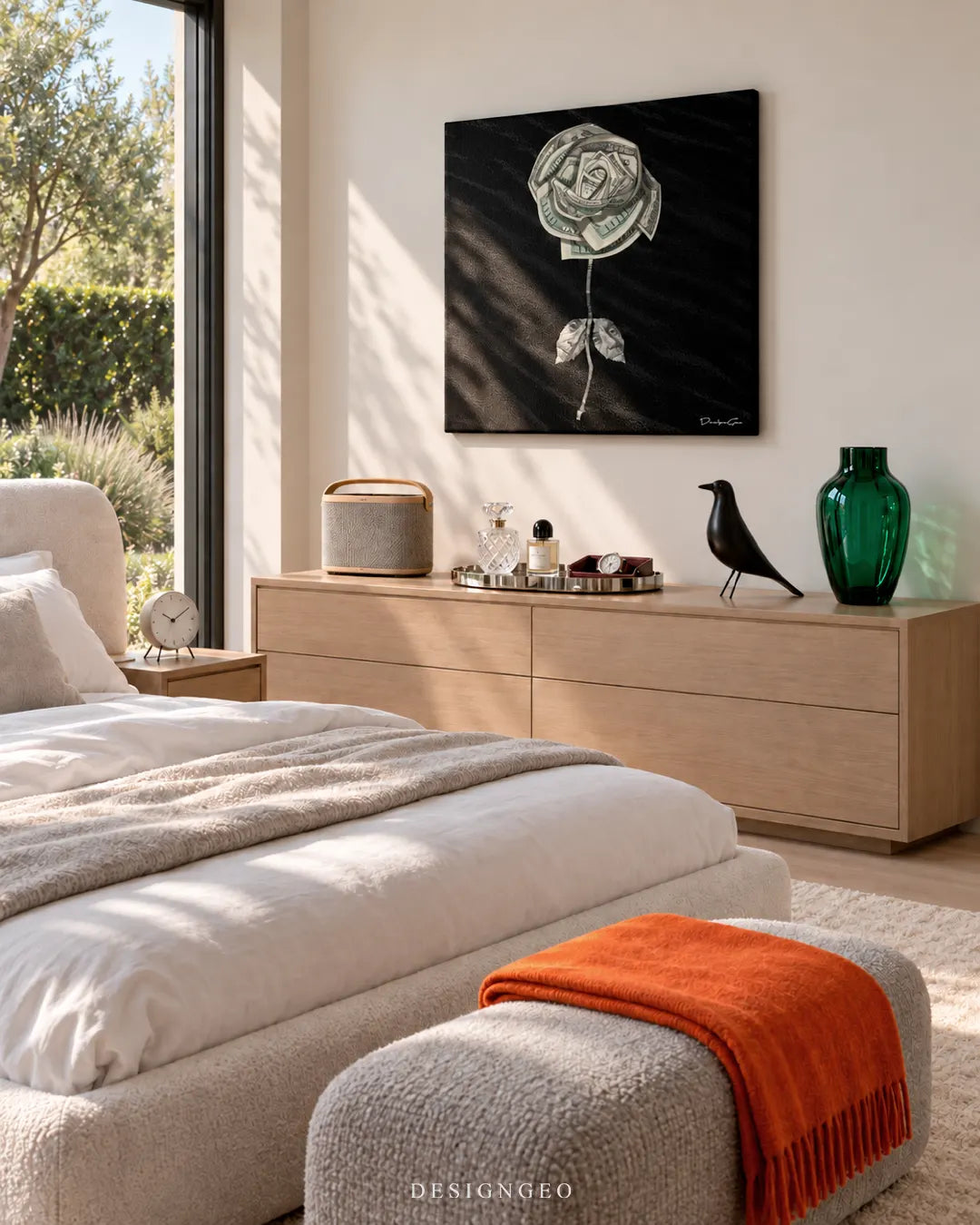 Square black canvas print showing a US dollar bill rose artwork hanging on a cream wall in a bright master bedroom above a natural oak dresser