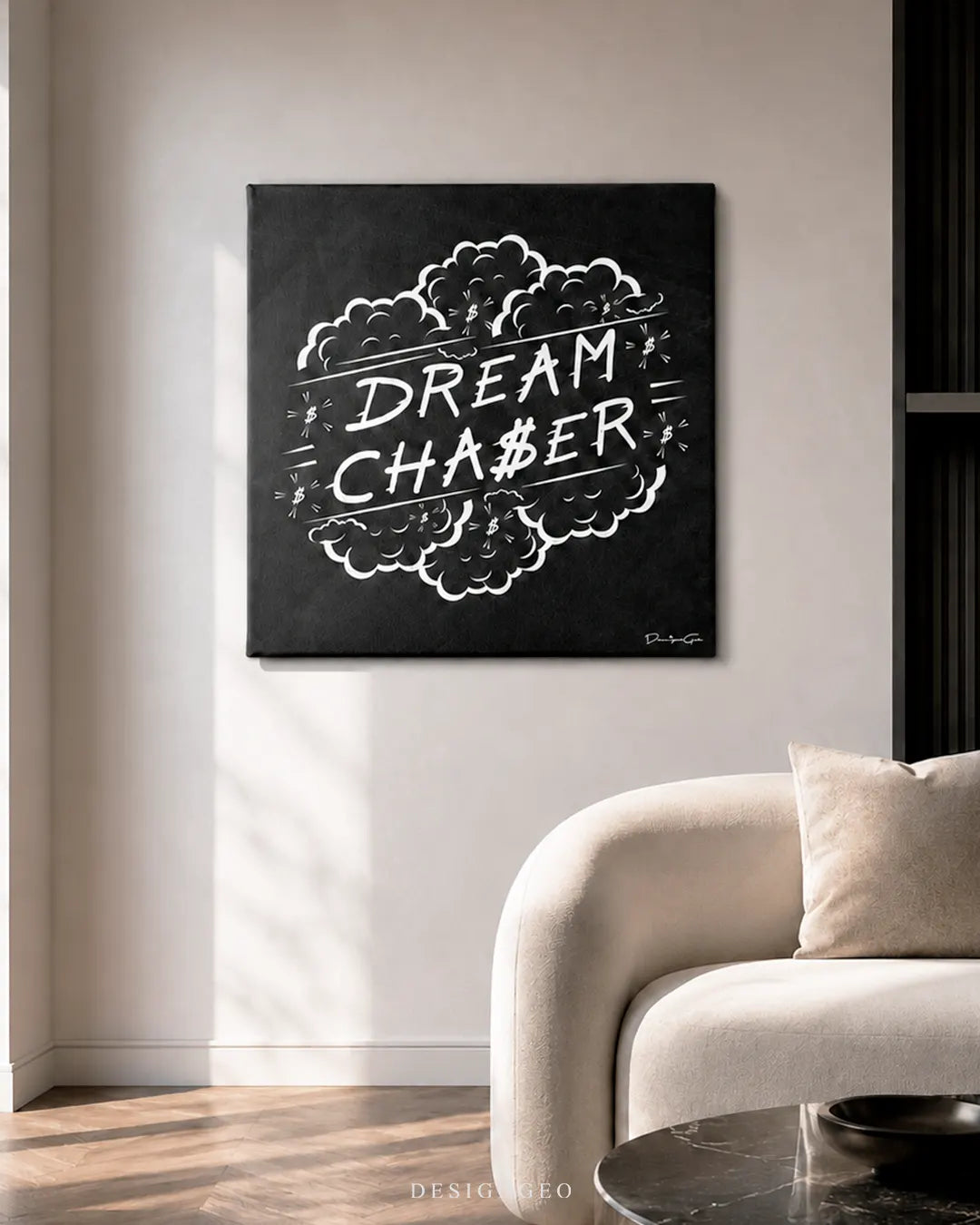 Square black Dream Chaser canvas print mounted on a neutral wall above a curved beige armchair in a sunlit modern living room