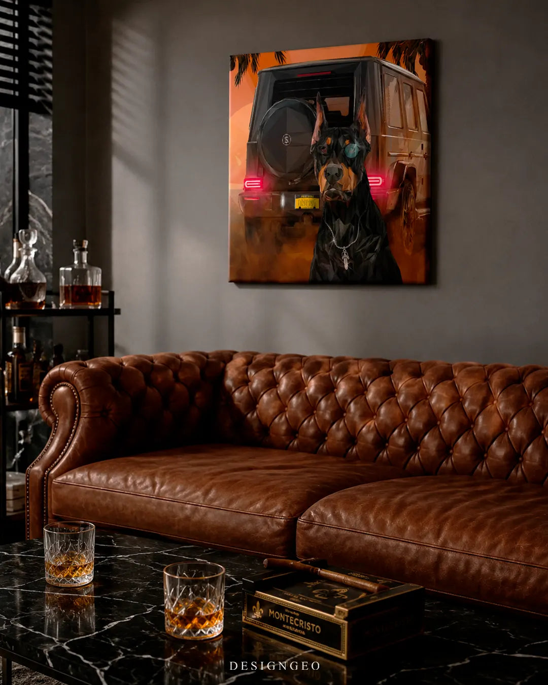 Square Doberman Dropout canvas print mounted on a dark grey wall above a tufted brown leather Chesterfield sofa, black marble coffee table, whiskey glasses, and Montecristo cigar box