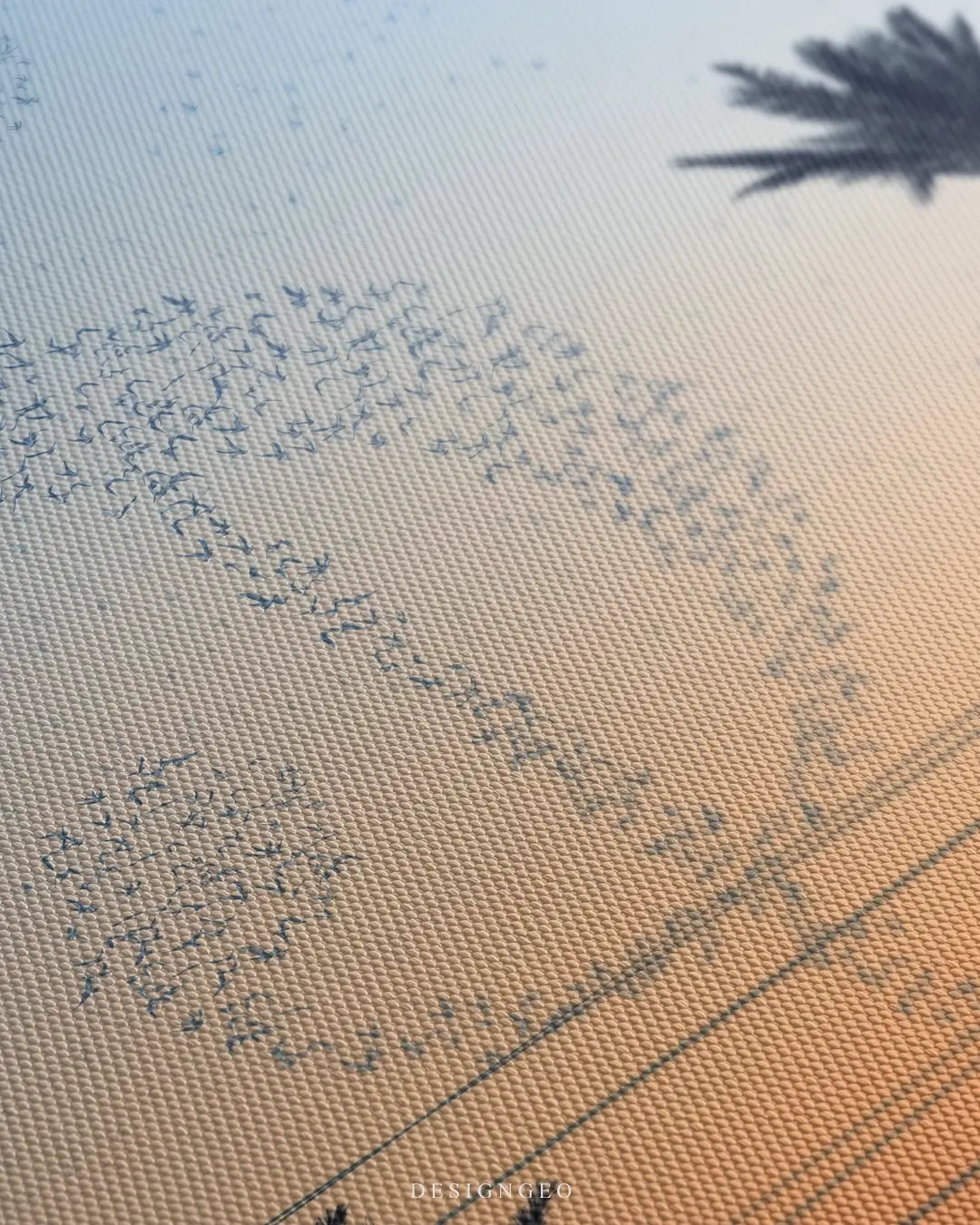 Close-up of modern motivational art featuring a flock of birds flying in a dollar sign formation against a soft, bright blue sky