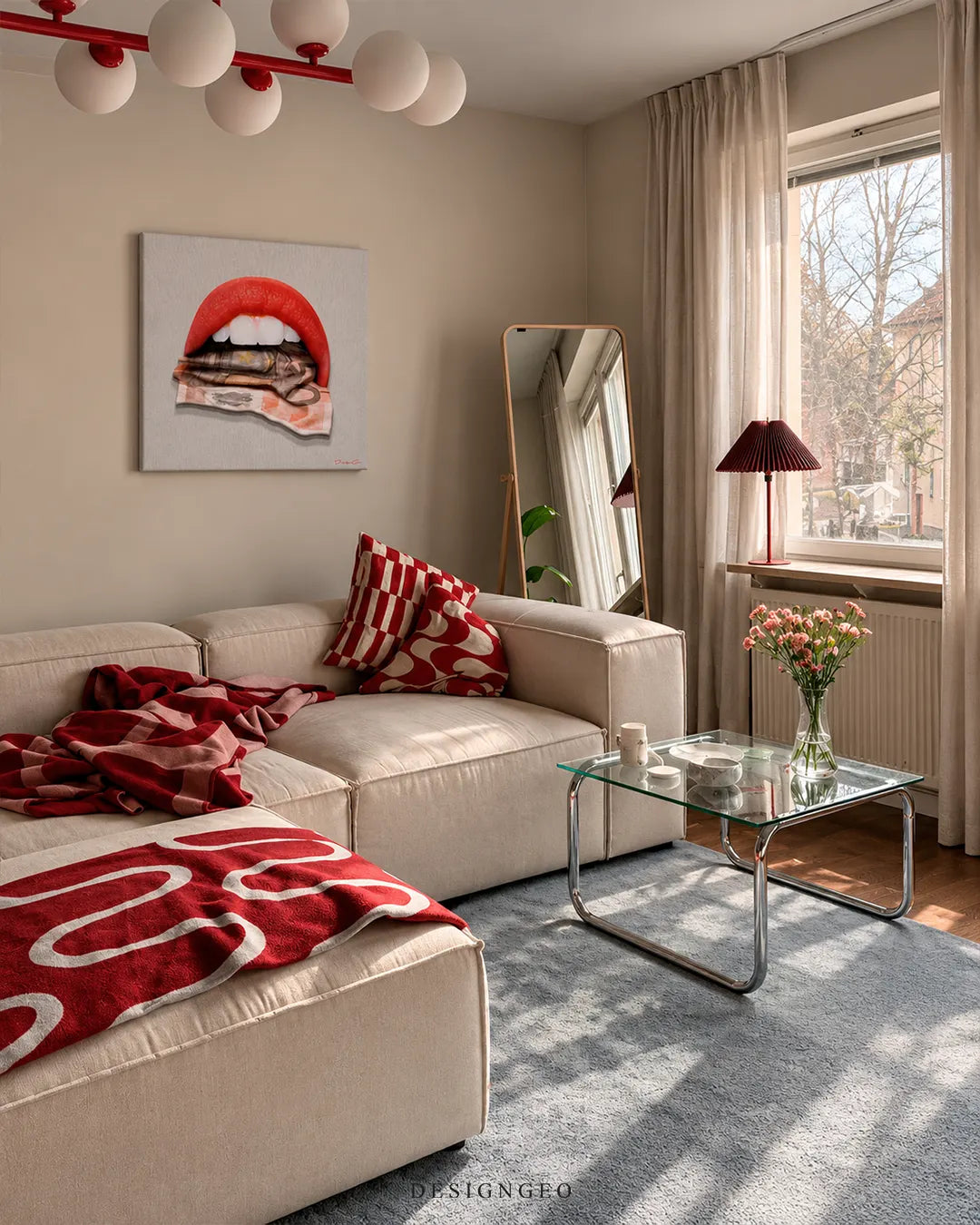 Square canvas print featuring glossy red lips biting a rolled Euro banknote mounted on a beige wall above a beige sectional sofa with red accents