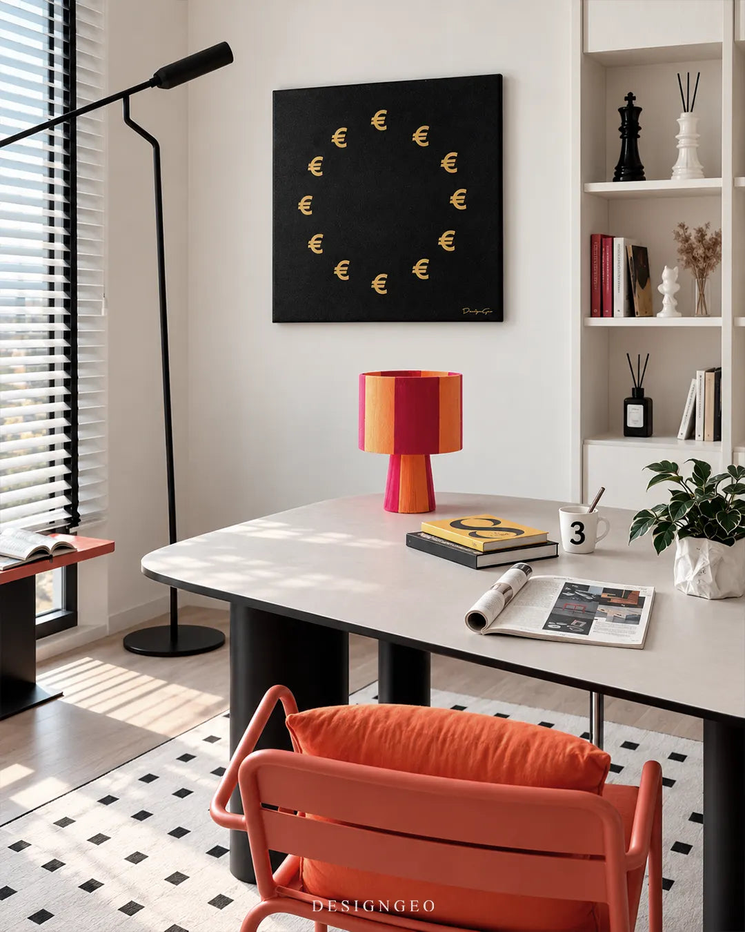 Square black canvas print featuring twelve golden Euro currency symbols arranged in a circle like the European Union flag mounted on a white wall above a modern office desk with an orange chair