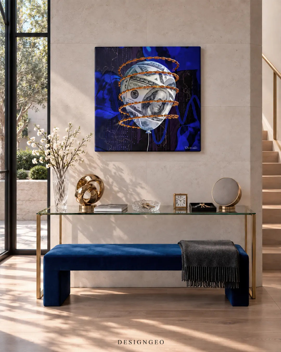 Square dark blue canvas print featuring a US dollar bill balloon wrapped in golden barbed wire mounted on a beige limestone wall above a glass console table and royal blue velvet bench
