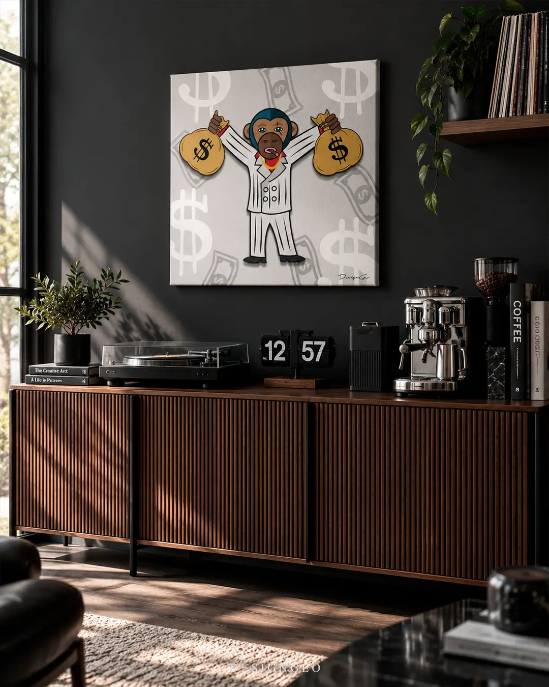 Square gray canvas print featuring a cartoon ape in a white suit holding two dollar sign money bags mounted on a dark charcoal wall above a mid-century modern wooden console in a bright lounge area