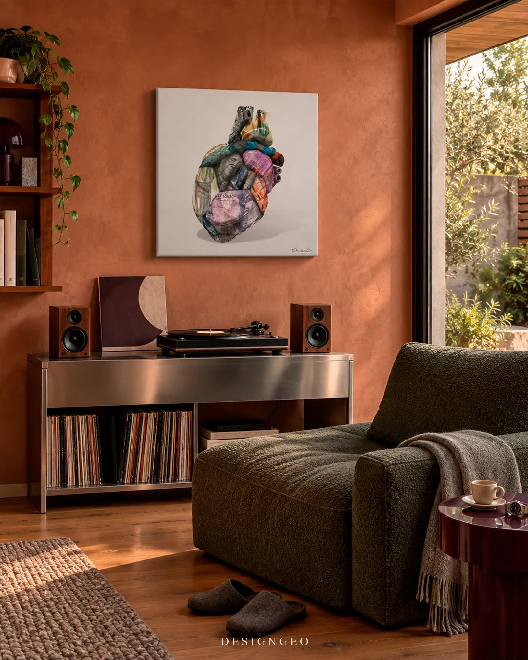 Anatomical human heart made of folded global currency bills square canvas wall art displayed on a terracotta wall in a modern listening room above a vinyl record console