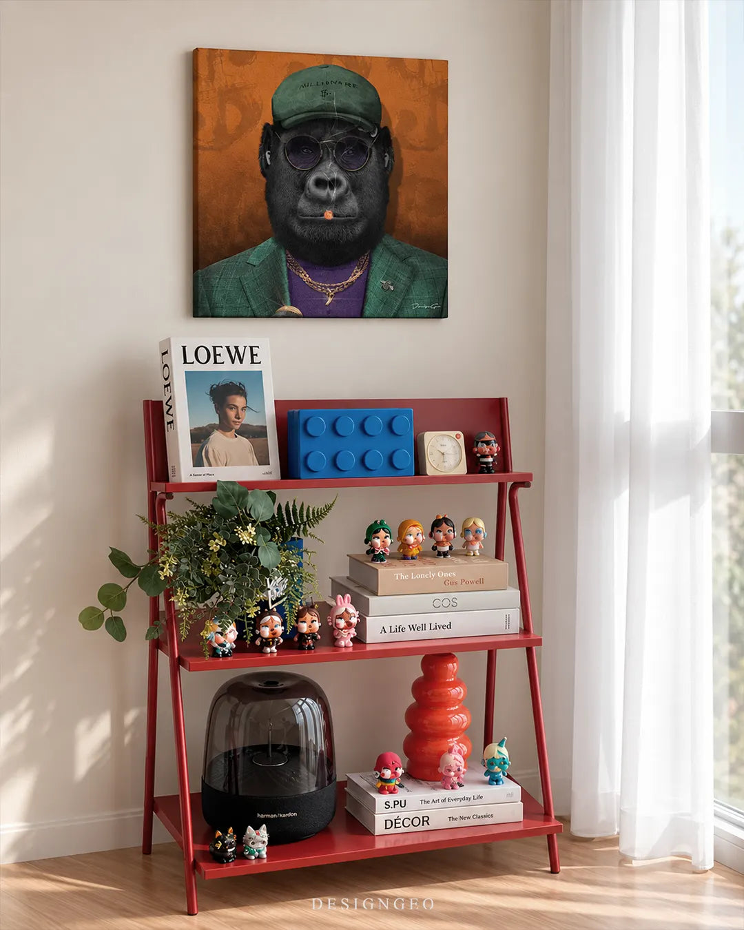 Square orange canvas print featuring a cool black ape in a green blazer, 'Millionaire' cap, and sunglasses smoking a cigar mounted on a white wall above a red eclectic shelf styled with modern collectibles and design books