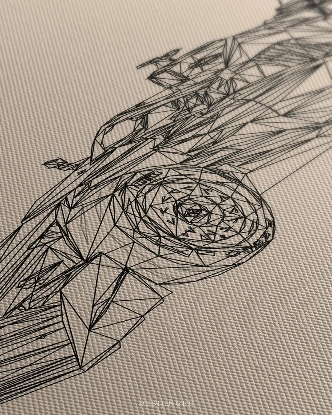 Close-up of minimalist racing wall art featuring a black line drawing of a Grand Prix car's aerodynamic profile on a light beige background
