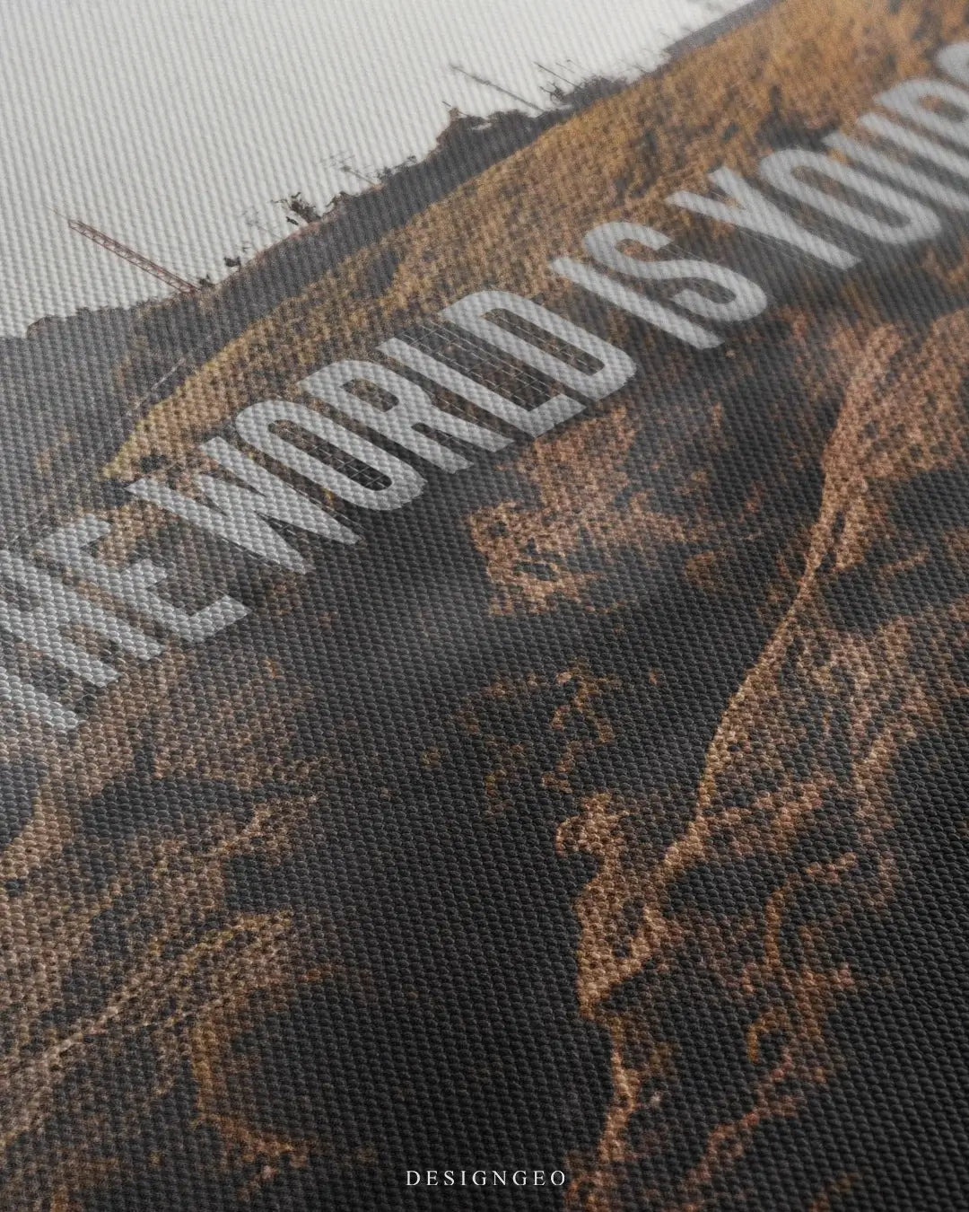 Close-up of motivational wall art featuring the iconic phrase The World is Yours replacing the Hollywood sign on the lush green hills of Los Angeles