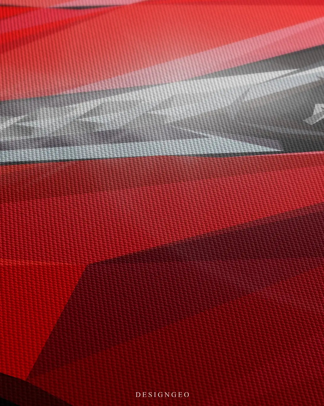 Close-up of luxury automotive wall art featuring the sleek front hood and aerodynamic curves of a red sport car on a red background