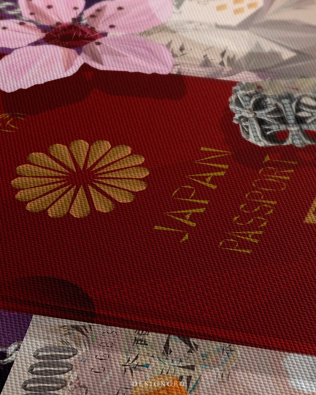 Close-up of a textured red Japan passport canvas print showing the gold foil Imperial Chrysanthemum emblem and pink cherry blossoms