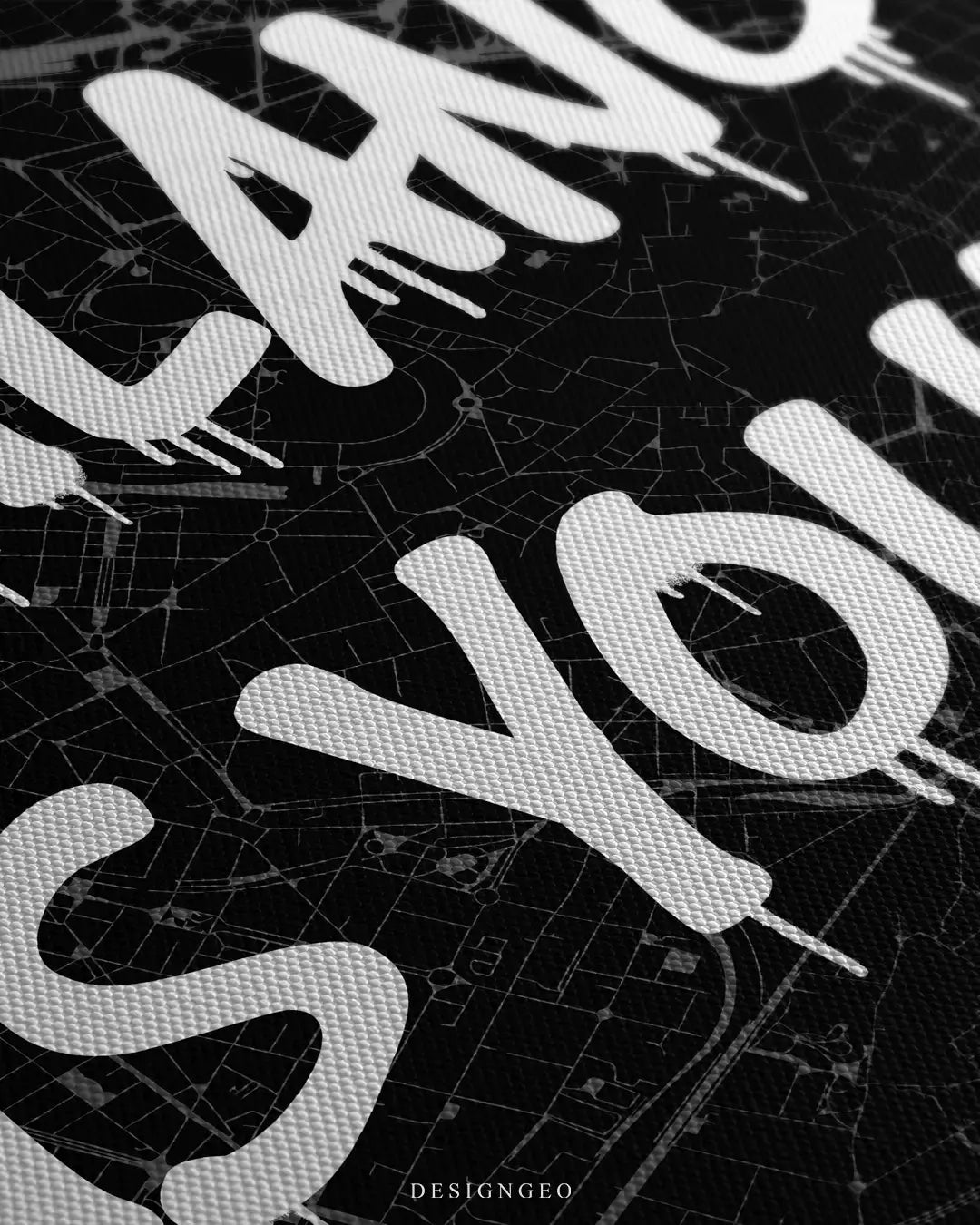 Close-up of a minimalist Milan city map canvas featuring detailed street grids and the motivational phrase "Milano is Yours" in white graffiti style on a black background