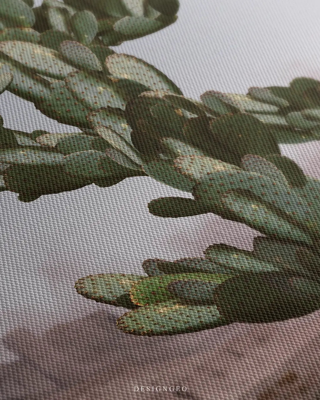 Close-up of modern wall art featuring a green cactus shaped like a dollar sign, symbolizing financial growth and resilience in a vast desert landscape