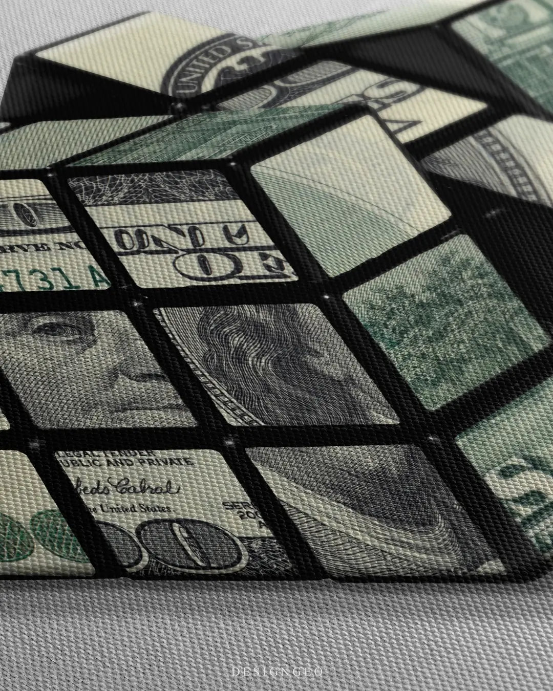 Close-up of modern money wall art featuring a perfectly structured cube made of realistic $100 dollar bills on a clean white background