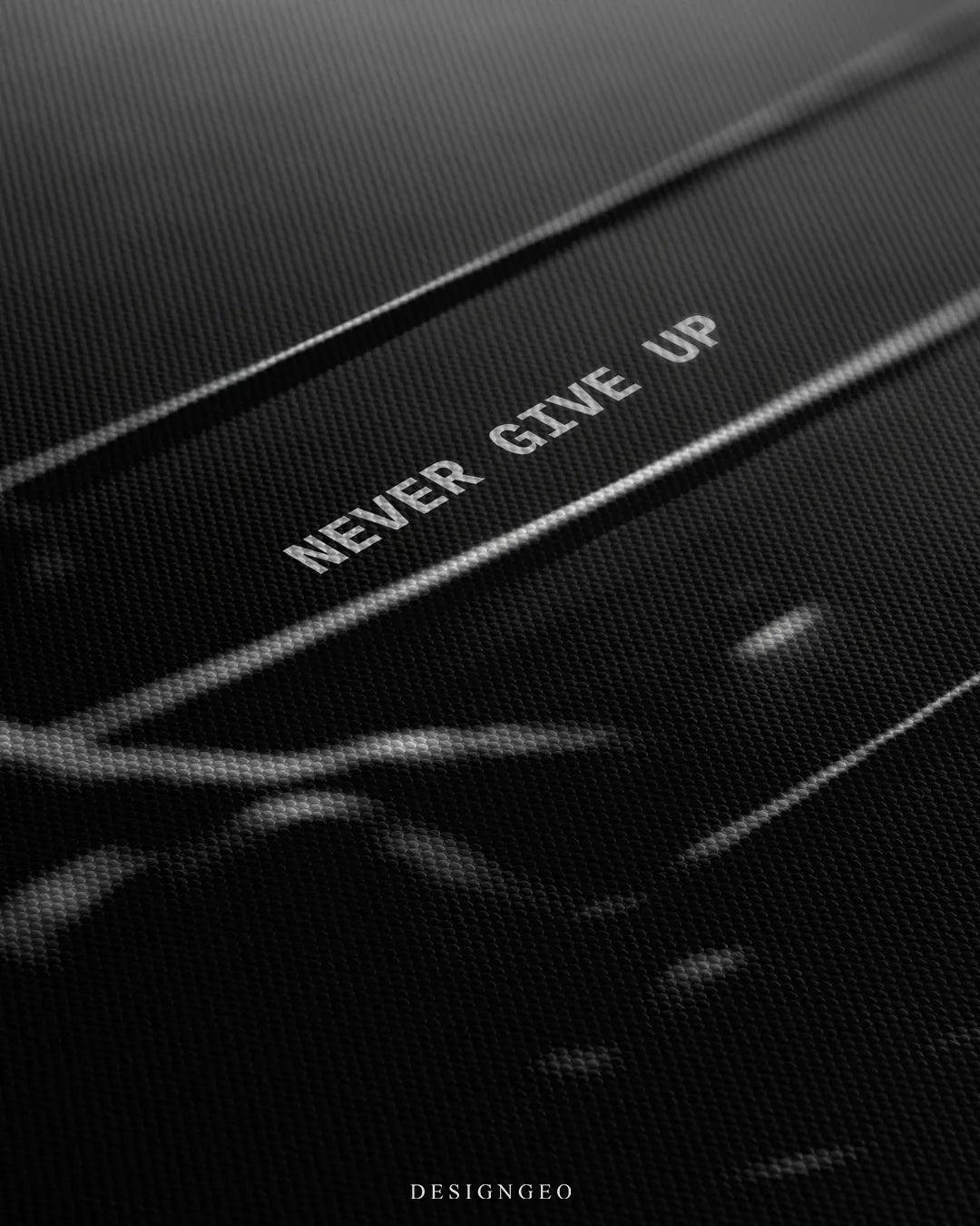 Angled detailed macro texture of black woven canvas print showing Never Give Up quote near boxing ring corner ropes