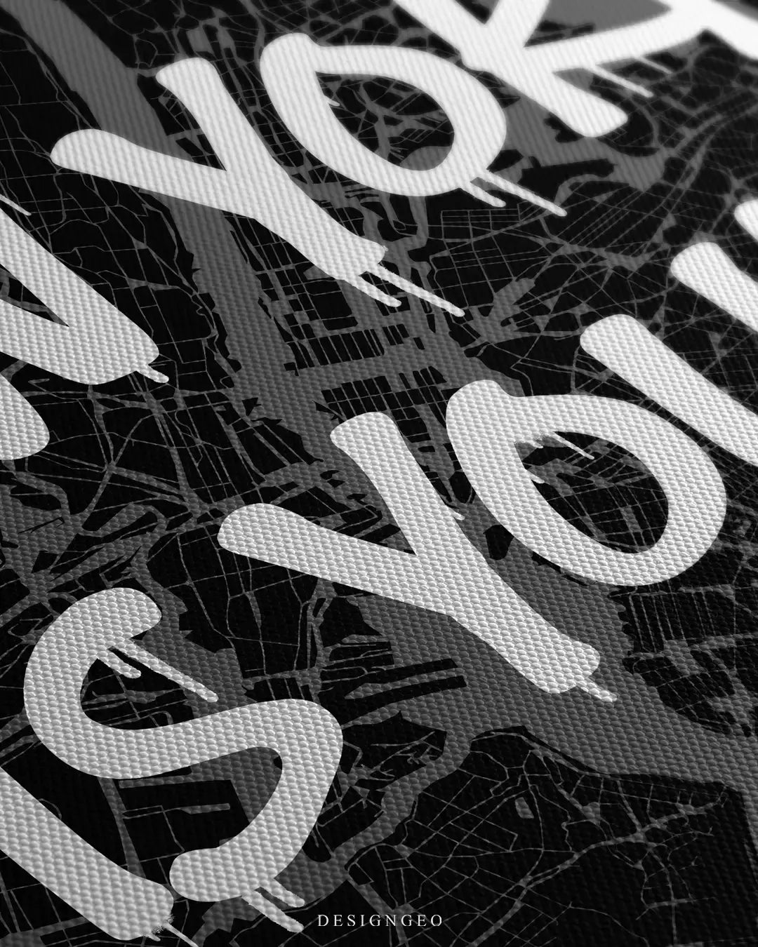Close-up of a minimalist New York City map canvas featuring detailed urban street grids and the motivational phrase "New York is Yours" in bold white graffiti typography on a dark background