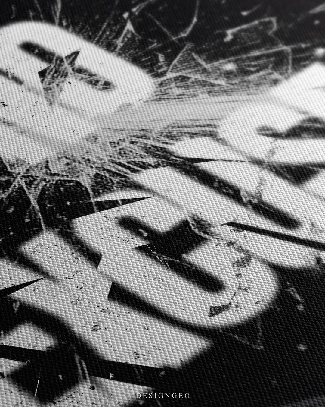 Angled close-up detail shot highlighting the fine canvas weave texture and distressed white typography with sharp glass crack overlays