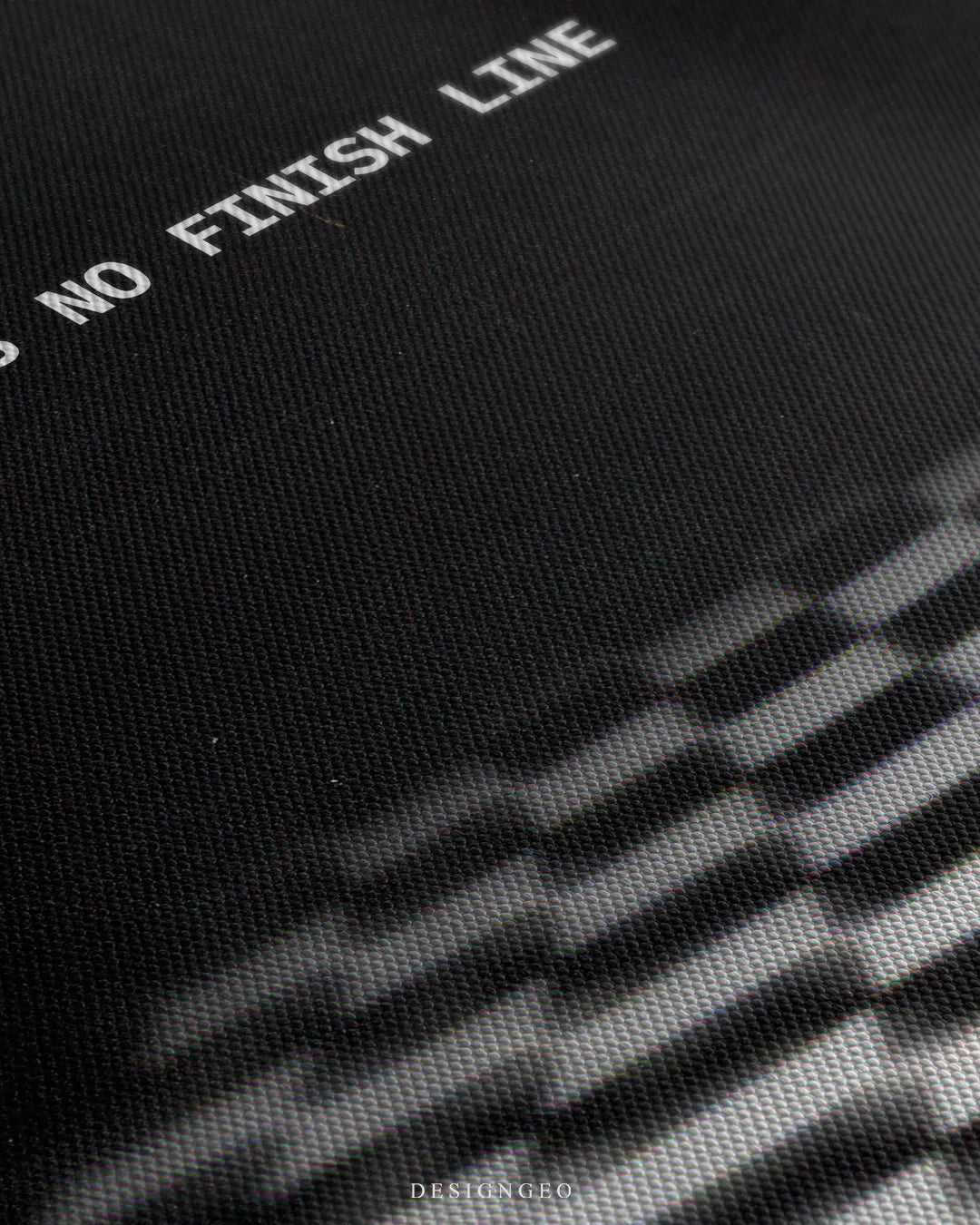 Angled macro view detailing fine woven canvas fabric texture, clean white typography printing, and sharp optical checkerboard pattern contrast