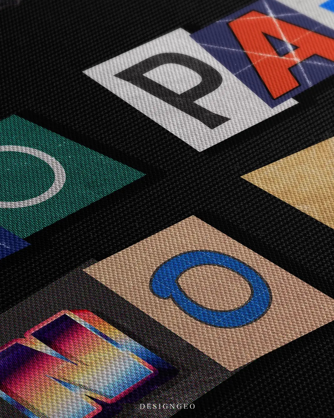 Close-up of modern motivational wall art featuring the phrase No Pain No Gain in vibrant, multicolored letters with a 3D effect on a solid black background