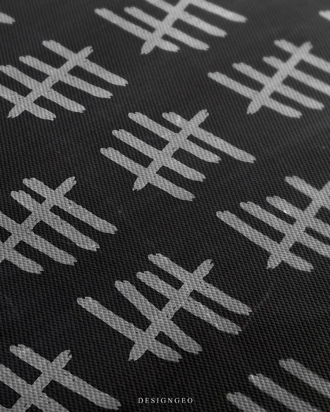 Angled close-up detail shot highlighting the grainy white chalk stroke texture of the tally marks and fine woven canvas fabric weave