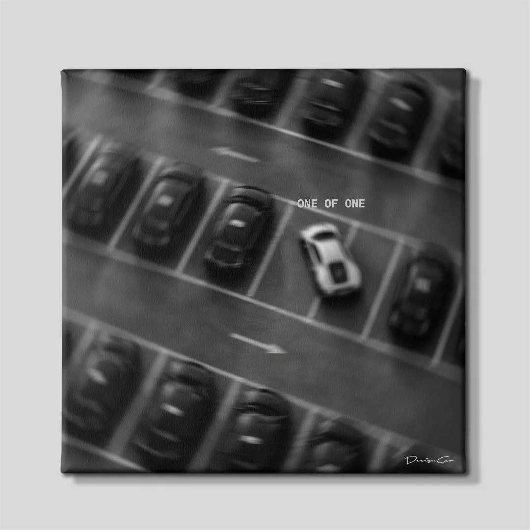 Aerial black and white square motivational canvas art featuring a single white sports car parked among dark vehicles under quote One Of One 0.75 inch thin wrap