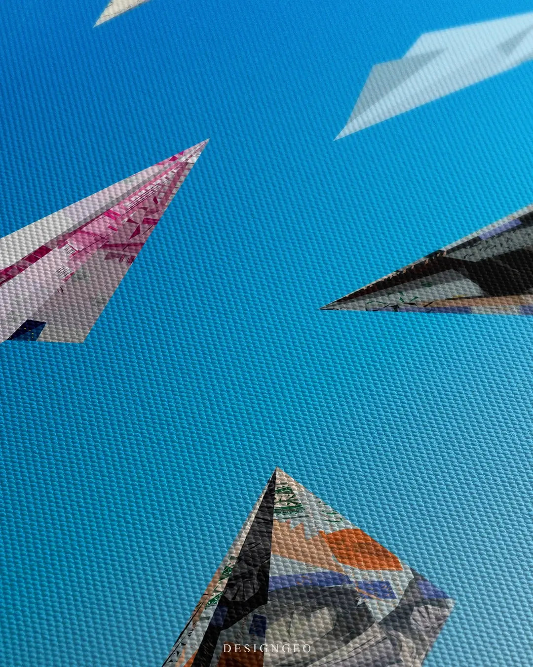 Close-up of modern motivational wall art featuring intricately folded paper planes made from various international currency bills on a light blue background