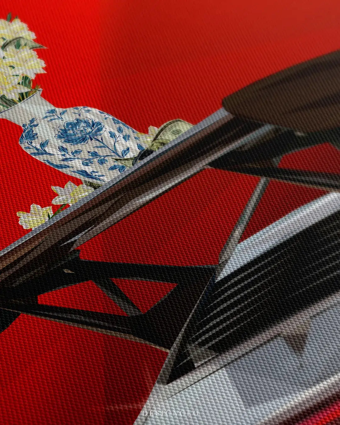 Close-up of modern canvas art showing a glass vase with flowers balanced on a carbon fiber sports car spoiler against a deep red background