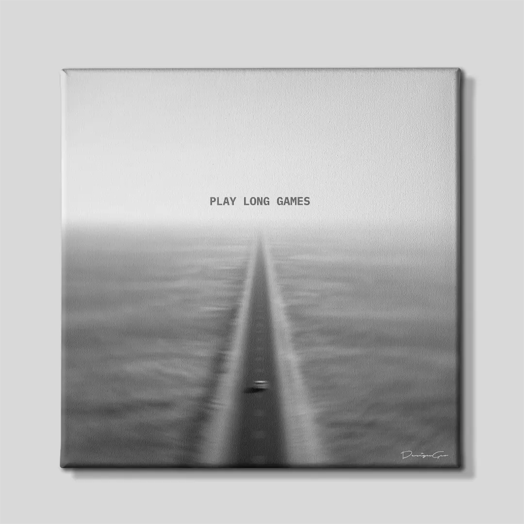 Black and white square canvas wall art featuring a car driving down a long straight highway fading into the horizon under quote Play Long Games 0.75 inch thin wrap
