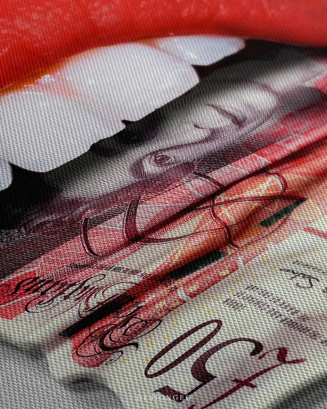 Close-up of motivational money wall art featuring a mouth biting a 50 British Pound Sterling note, highlighting the intricate banknote details on a clean white background