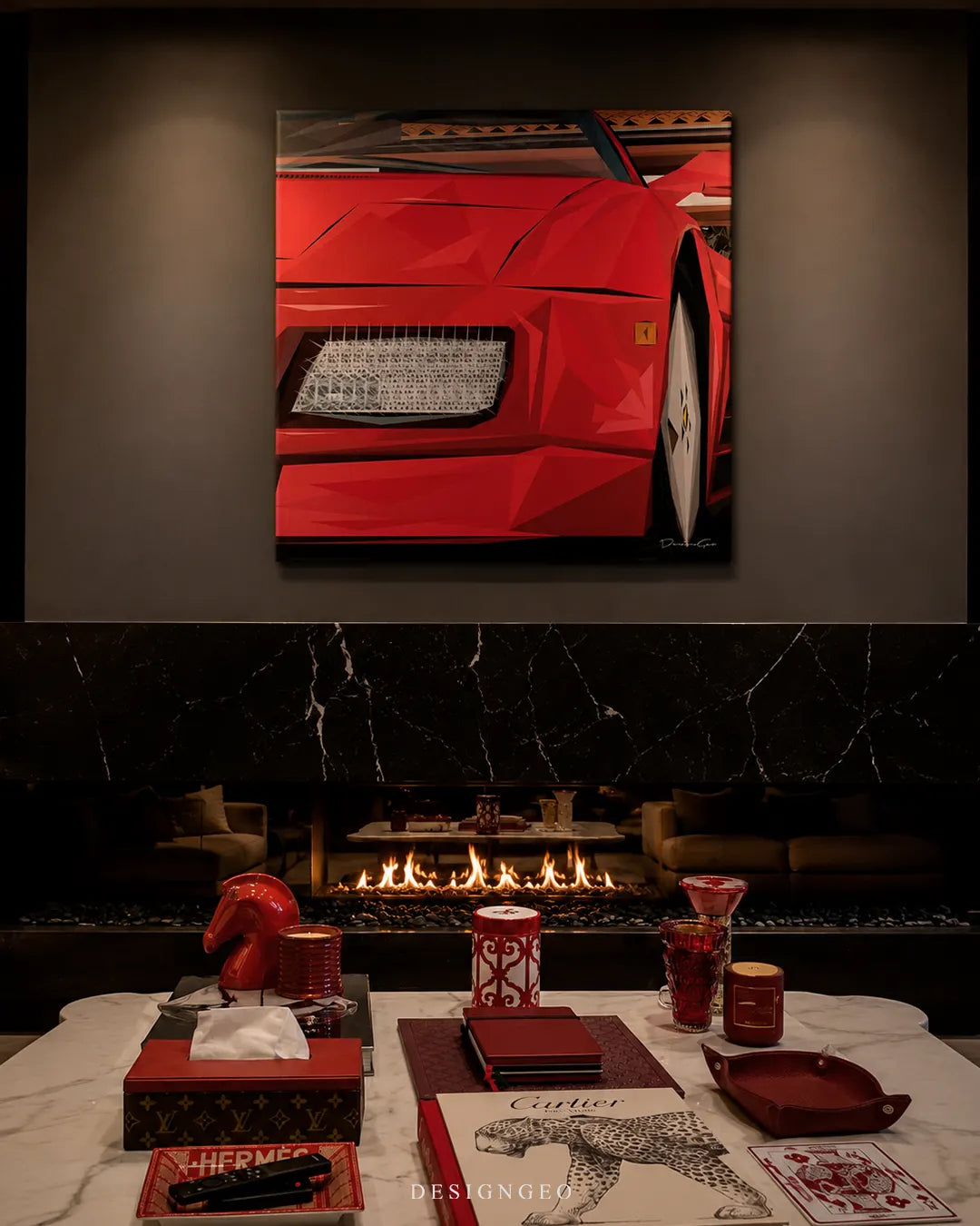 Square red sports car canvas print mounted above a dark marble modern fireplace with a white coffee table displaying books, accessories, and candles