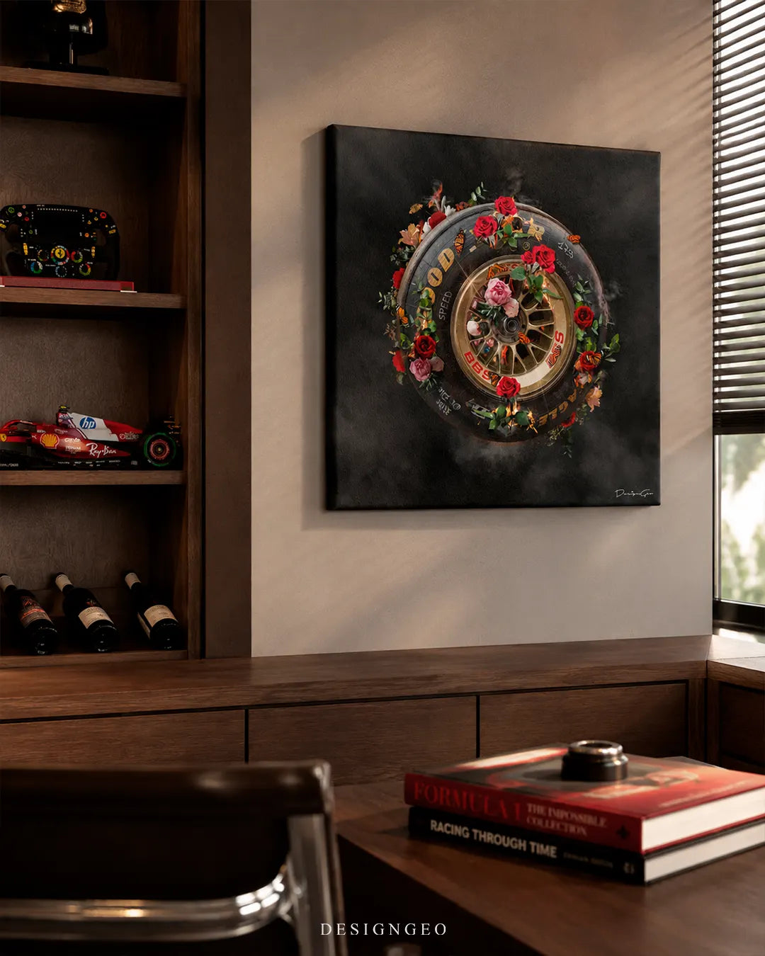 Square Ride or Die racing wheel canvas print mounted on a beige wall next to a wooden bookcase with F1 collectibles, wine bottles, and Formula 1 coffee table books