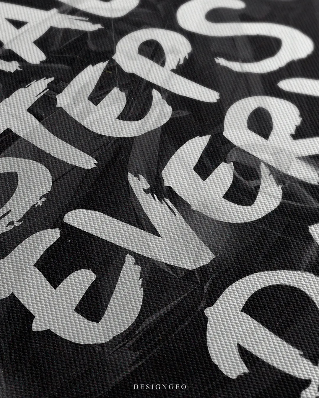 Angled close-up view of the canvas print surface, showing the detailed woven texture and white painted brush stroke letters spelling "STEPS EVERY"