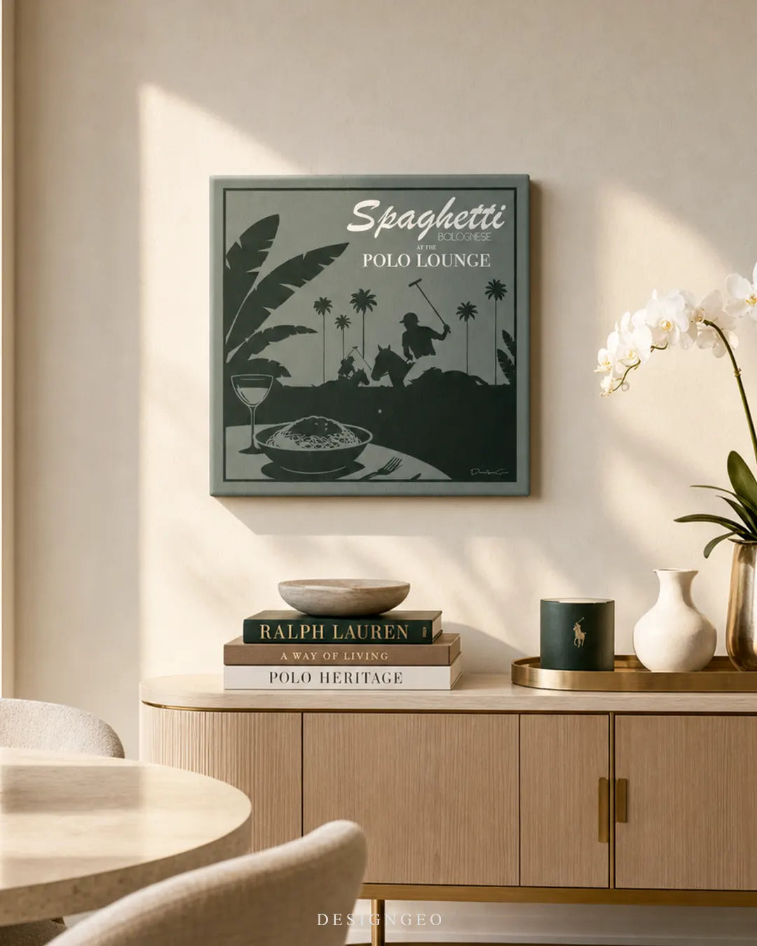 Elegant dining room with warm ambient lighting, featuring the square Spaghetti Bolognese at the Polo Lounge canvas print mounted above a light wood console table with coffee table books and white orchids