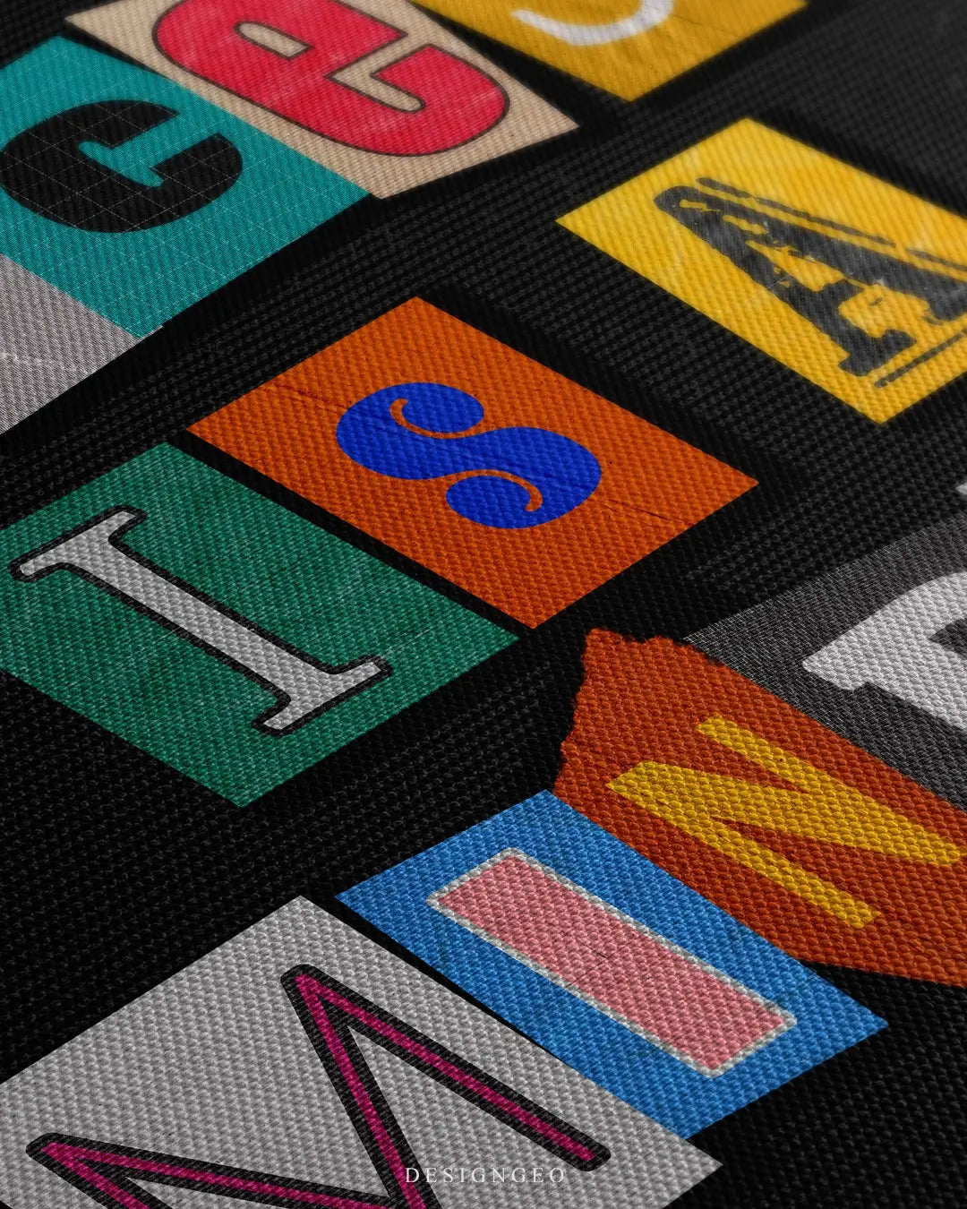 Close-up of motivational canvas art with the phrase "Success is a mindset" in vibrant colorful typography, highlighting detailed paint textures on a black background