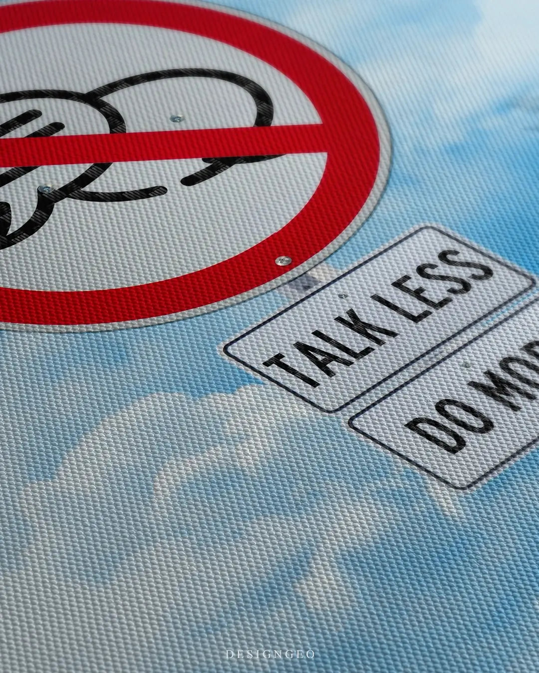 Close-up side view of a canvas wall art with the motivational quote TALK LESS DO MORE, showing high-definition design on a textured canvas print