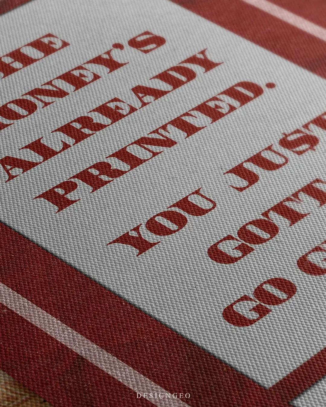 Close-up of motivational money art featuring a thick stack of British Pound (GBP) banknotes with the phrase "The money is already printed" in bold red typography