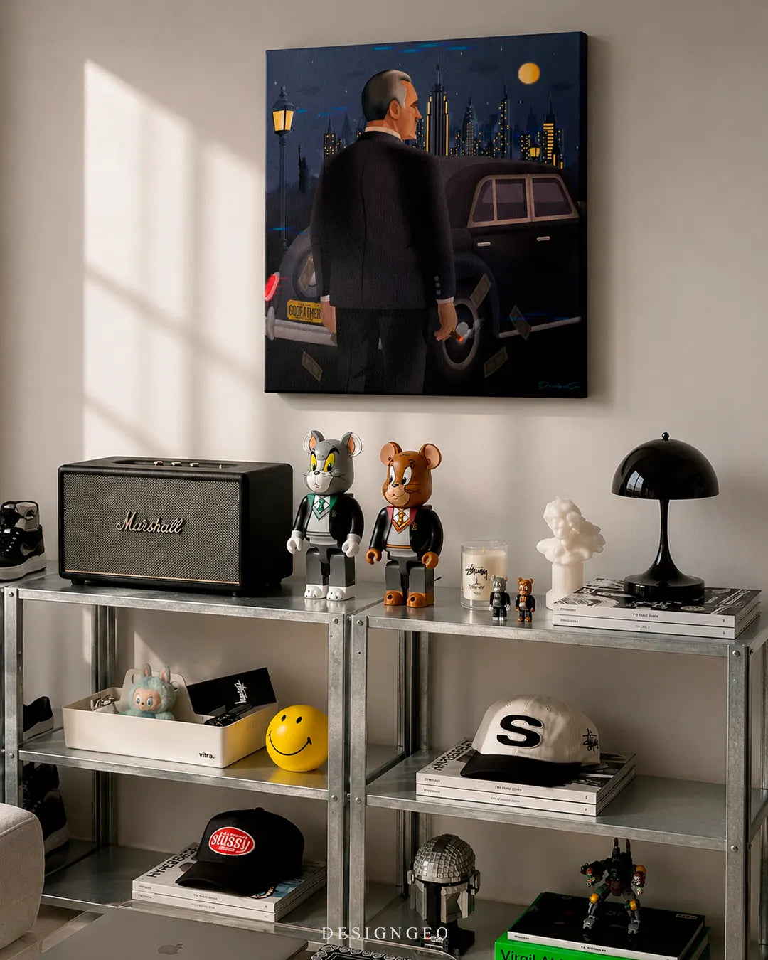 Square mafia boss NYC canvas print mounted on a beige wall above industrial metal shelving featuring a Marshall speaker, Tom and Jerry Bearbrick figures, and modern art books