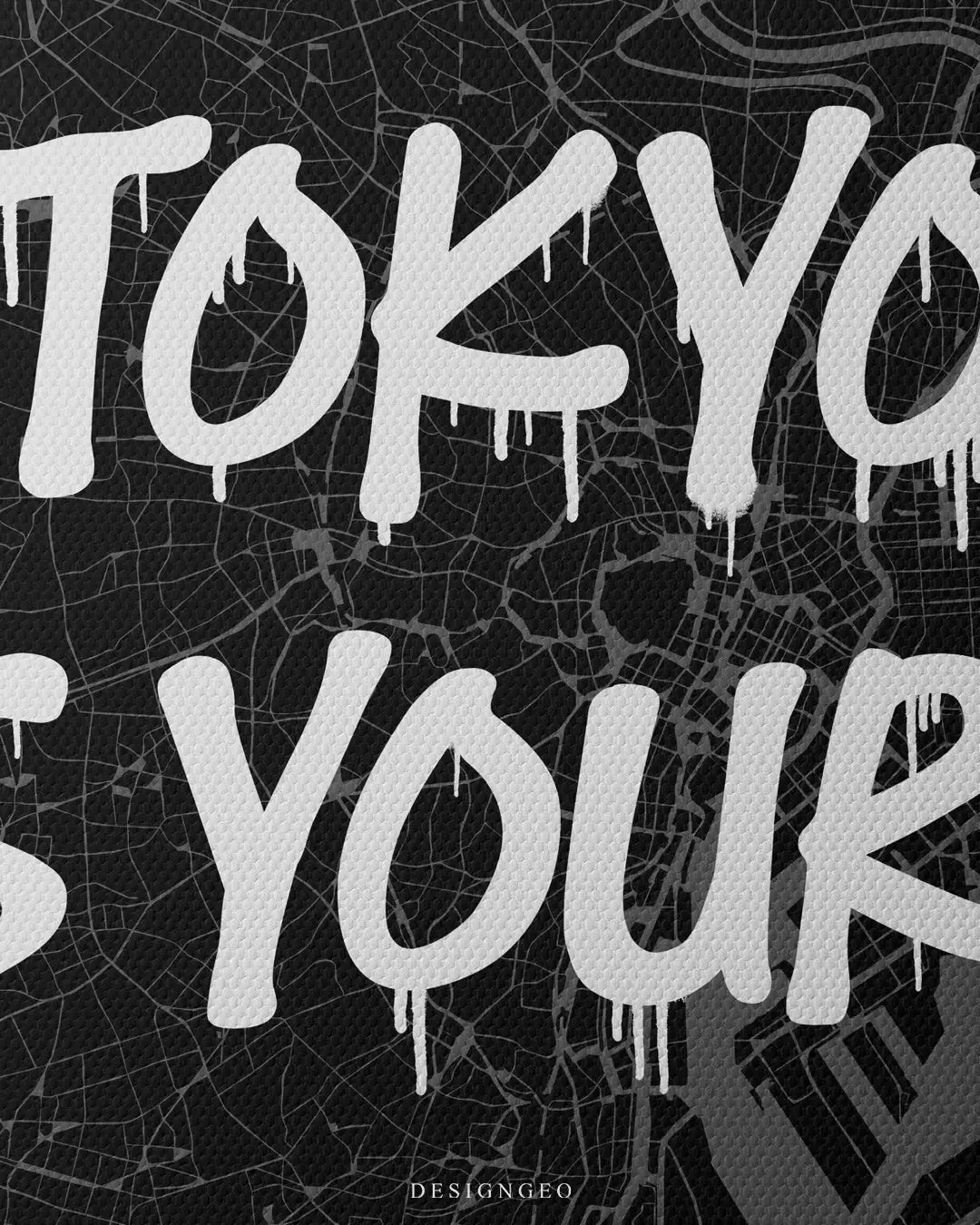 Close-up of modern Japanese style wall art featuring a detailed Tokyo city map layout with the motivational phrase "Tokyo is Yours" in bold white graffiti typography on a dark background